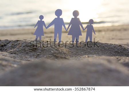 family paper cut stand on sand sunset time
