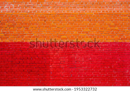solid texture of an empty brick wall of two shades of red and yellow for background and wallpaper