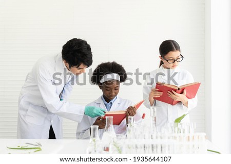 Asian man scientists and diversity children doing tests of plants in classroom. Group of diversity scientists learning science and doing analysis for germs and bacteria with microscope and glassware