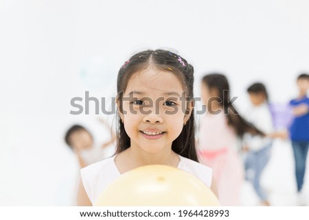 Cute Asian little girl playing balloon in the nursery school with happy and smile