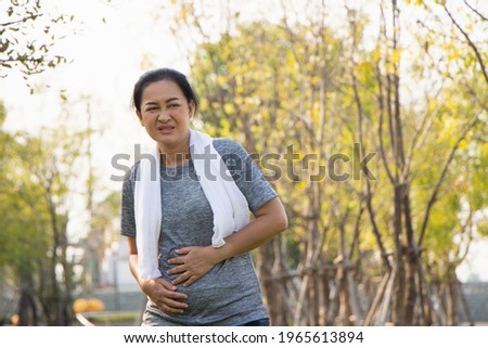 Old Asian people suffer from exercise pain.The old woman suffered from pain in the stomach.