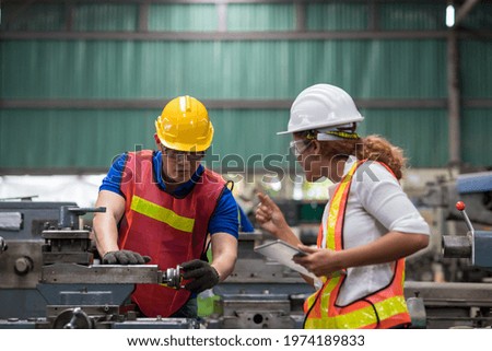Group of male and female worker maintenance machine in industry factory. Technician worker working, repair machine lathe metal in the industry factory