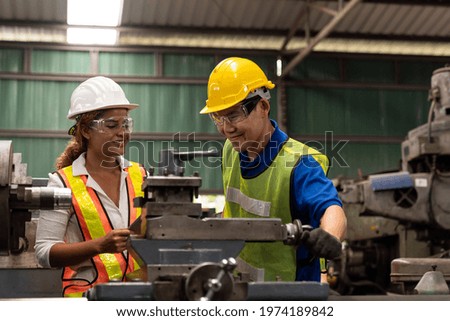 Group of male and female worker maintenance machine in industry factory. Technician worker working, repair machine lathe metal in the industry factory