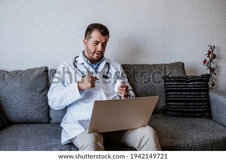latin doctor man consulting online and working with computer at home in Mexico city