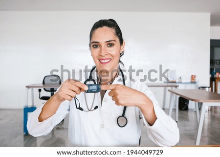 Portrait Of latin Female Doctor Wearing White Coat With Stethoscope In Hospital Office in Mexico city