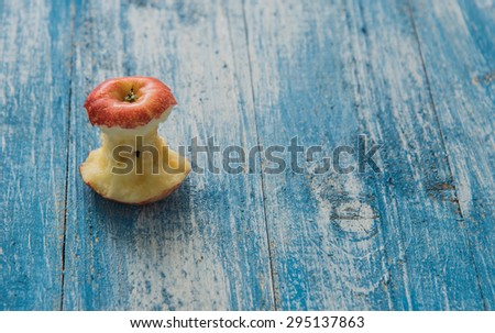 Apple bitten laid out on a wooden floor in blue and white.