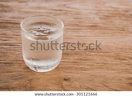 Drink a glass of water Place the left side on a wooden floor Focus on water.