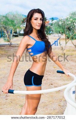 Standing Happy Woman In Sports Bra And Gym Shorts Posing For The