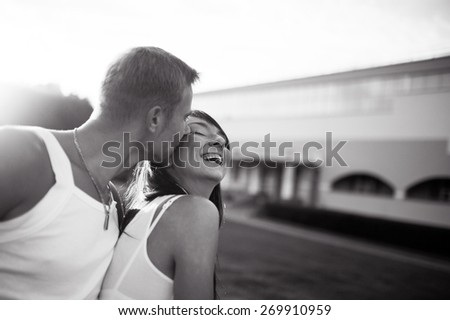 slender young happy couple sports girl and man on a picnic in the park