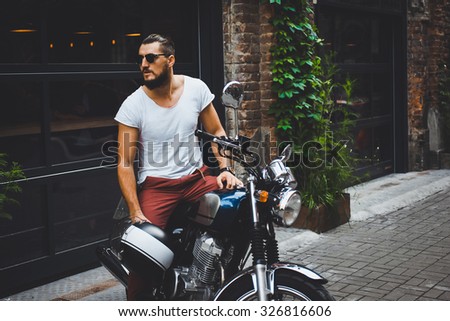 Indian man posing in an urban context.