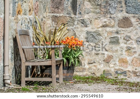 Bench in front of stone wall
