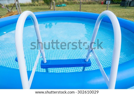 Inflatable swimming pool with ladder