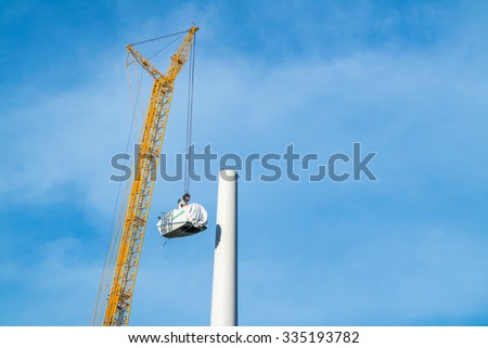 MOERS / GERMANY - NOVEMBER 03, 2015 : Giant crane lifts driver\'`s cab up to the wind generator