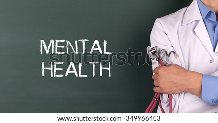 Doctor Standing front of Blackboard written MENTAL HEALTH