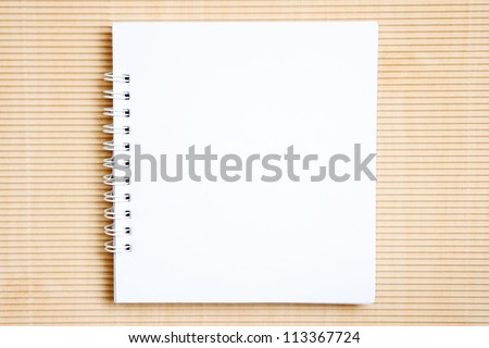 Blank notebook on brown paper background