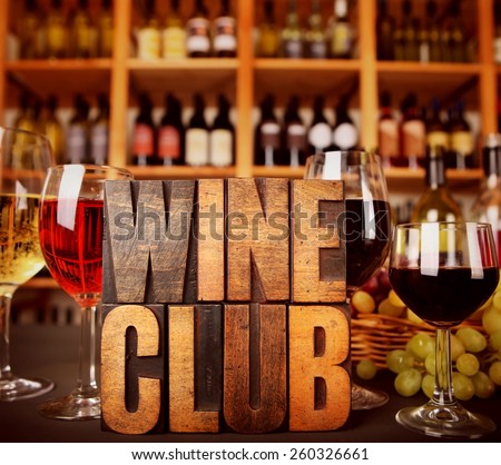 Wine Club in Vintage Letterpress letters in front of wine racks with wine and grapes