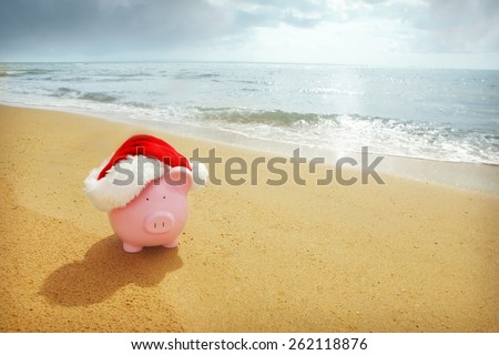 Piggy Bank with Santa hat at beach - Australian Christmas Savings