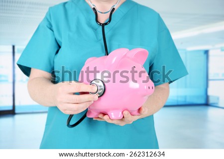Health care worker with Piggy Bank