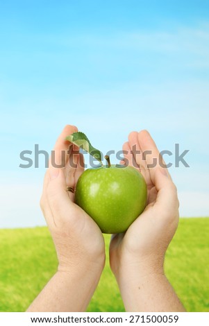 Delicious granny smith apple in hands