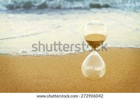Sand timer on beach
