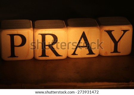 Building Blocks in the Dark with Light spelling out pray