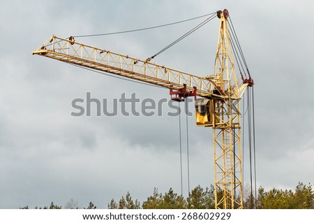 Yellow building tower crane. Construction concept