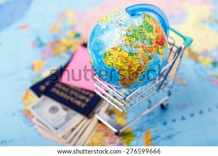 Passports, money, tickets, globe and map of the world as a vacation concept. Summer journey preparation. Planning holidays, checking documents, choosing destination point, having fun.