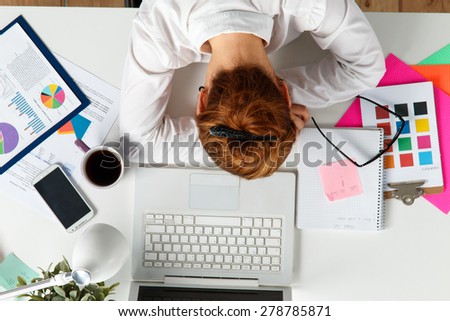 Tired female employee at workplace in office taking nap. Sleepy worker early in the morning after late night work. Creative person (designer or artist) in despair caused by deadline concept