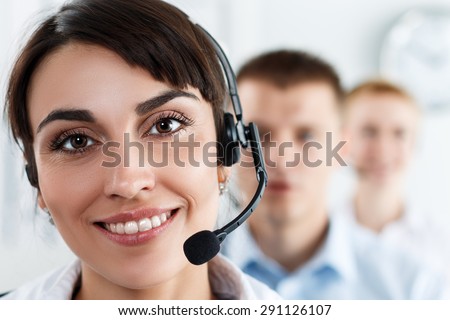 Three call center service operators at work. Portrait of smiling pretty female helpdesk employee with headset at workplace. Effective and efficient business information, help and support concept
