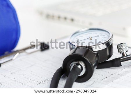Medical manometer lying on cardiogram chart closeup. Medical help, prophylaxis, disease prevention or insurance concept. Cardiology care,health, protection and prevention. Healthy life concept