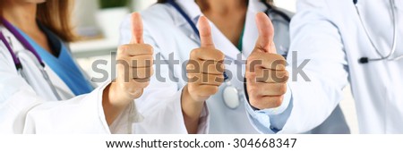 Three medicine doctor hands showing OK or approval sign with thumb up in row. High level and quality medical service, best treatment and patient care concept. Satisfied and happy interns. Letterbox