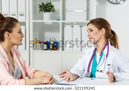 Concerned beautiful female medicine doctor listening carefully patient complaints. Medical care or insurance concept. Physician ready to examine patient and help. Partnership trust and ethics concept