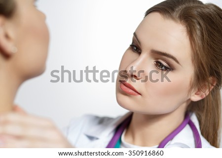 Beautiful female medicine doctor with serious face examine patient. Medical care, illness diagnosing, physical, physician consultation, isurance concept. Dermatologist or oncologist examination
