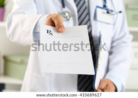 Male medicine doctor hand hold clipboard pad and give prescription to patient closeup. Panacea and life save, prescribe treatment, legal drug store, contraception concept. Empty form ready to be used