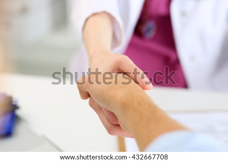 Female medicine doctor shake hand as hello with male patient in office closeup. Welcoming friend, introduction or thanks gesture. Tests advertisement concept. Physician ready to examine patient