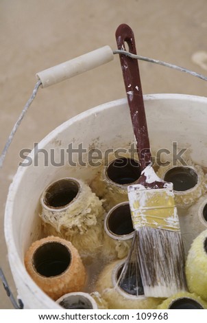 Paint Brush and Paint Rollers in Bucket