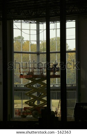 Silhouette of a Construction Worker on Scissor Lift