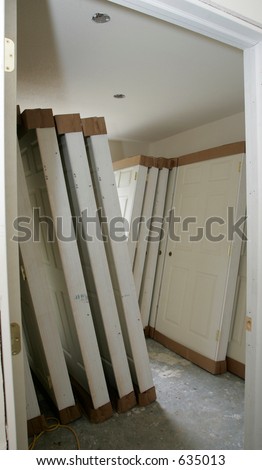 Interior doors stacked in a room waiting for installation