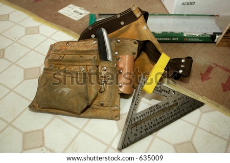 Carpenter\'s Tool Belt sitting on vinyl flooring