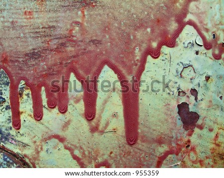 close up view of dry red paint drips on green metal