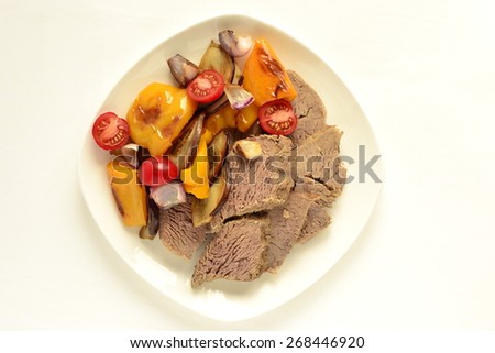 Boiled beef with baked vegetables