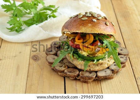 Wholegrain burger with fresh vegetables on a wooden background, vegetarian