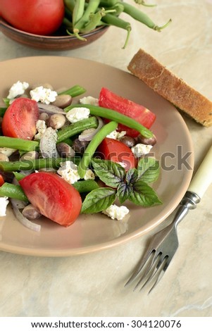 Bean salad with tomatoes, green beans and feta, vertical