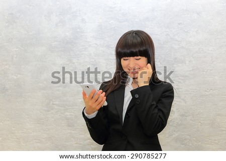 Woman is glad to see her cell phone.