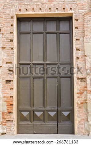 old and big brown wooden door, closes the access of a church