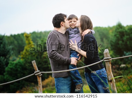 Happy parents with son in a park