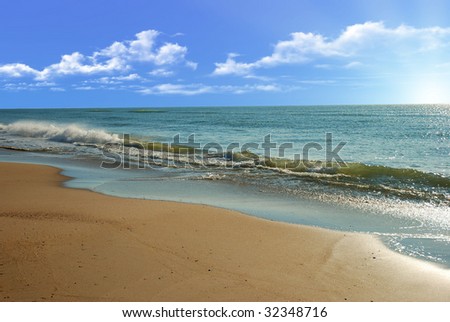 Morning seaside with gold sand and blue sky