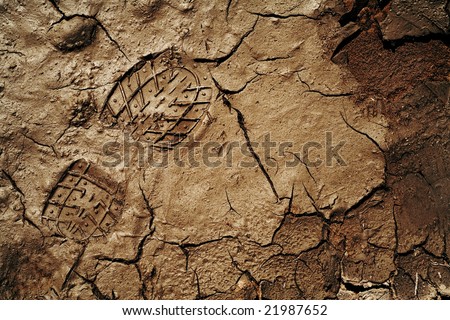 Footprint on the cracked earth background