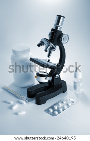 Microscope and pills, blue toned