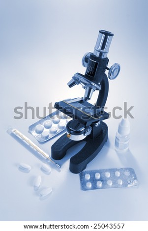 Microscope and medicines, blue toned